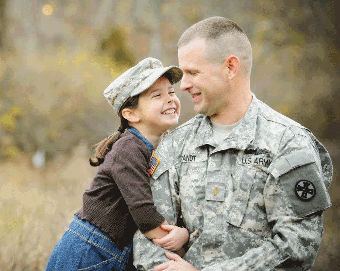Brandt in uniform with daughter, Katy wearing his hat in 2012.