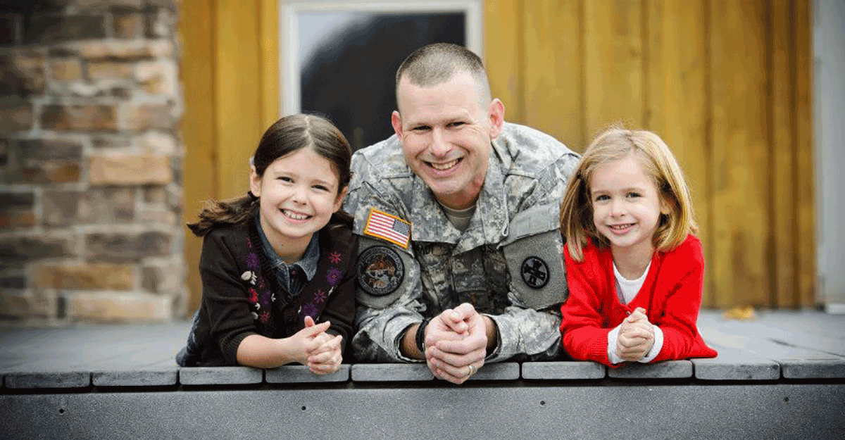 Brandt in uniform with young daughters.