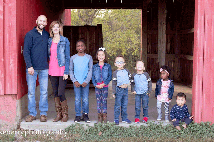 Keller and wife Chelsea stand for a family photo with their six children