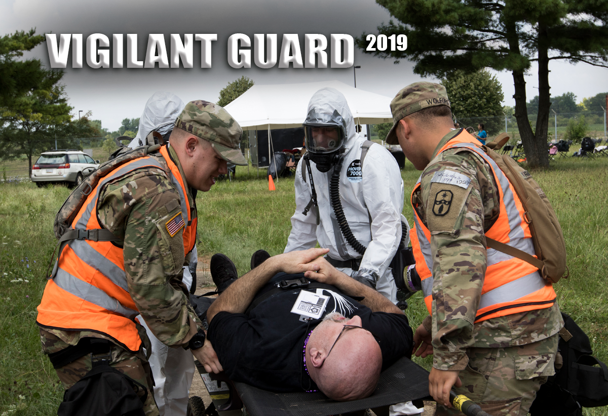 Soldiers prepare a simulated casualty for evacuation in field.