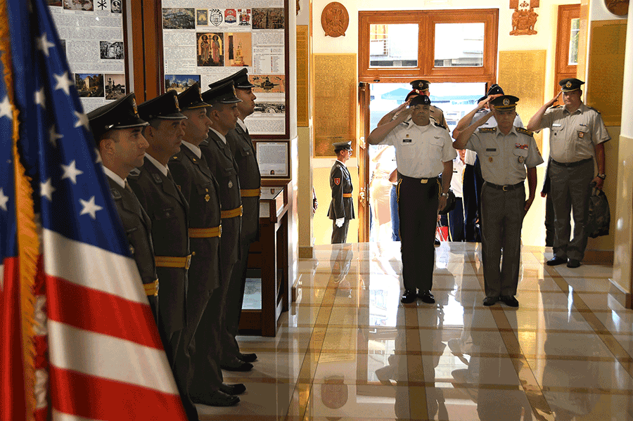  Maj. Gen. John C. Harris Jr. and Serbian Armed Forces Lt. Gen. Milosav Simović stand at attention and salute.