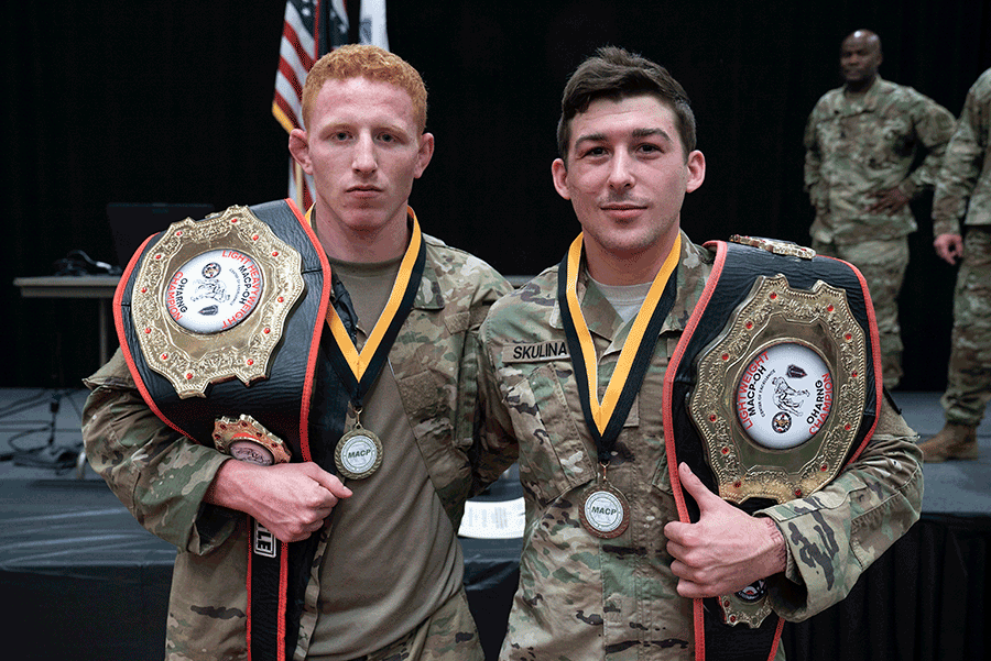 Two Soldiers show off their championship belts.