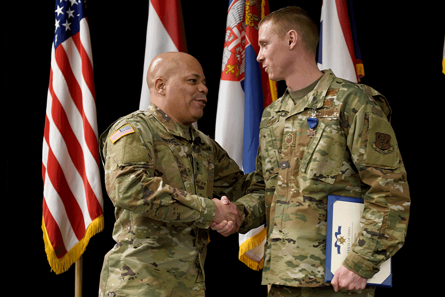 Ohio Adjutant General shakes hands with Tucker.