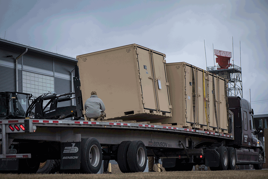 Pallets loaded onto flatbed trailer for transport.
