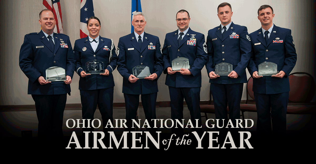 Six Airmen stand with awards.