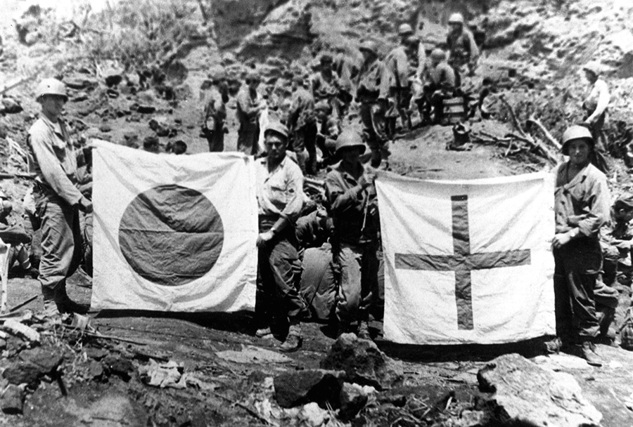 Soldiers display Japanese flags.