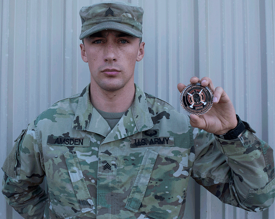 Sgt. Aaron Amsden holds a challenge coin.