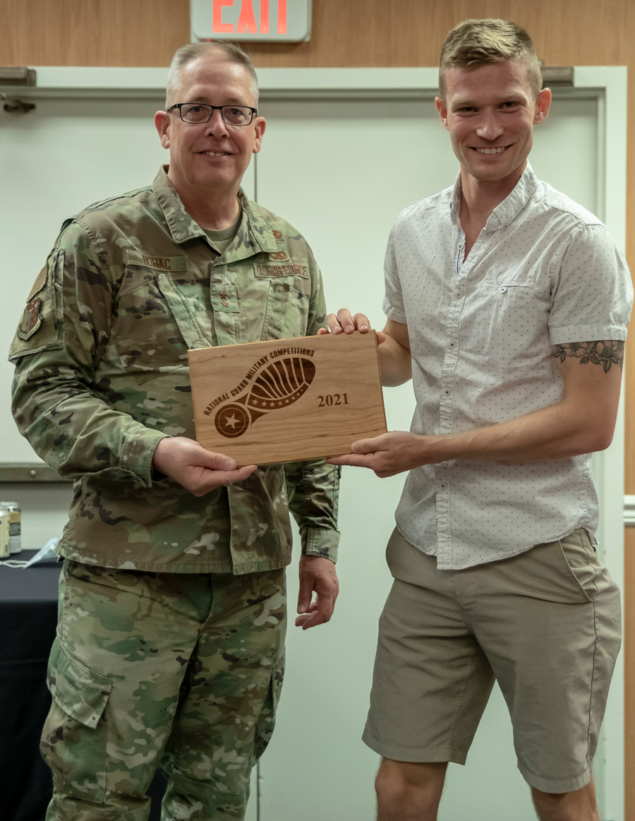 Maj. Gen. Daryl L. Bohac poses with Spc. Nathaniel Sink holding his award.