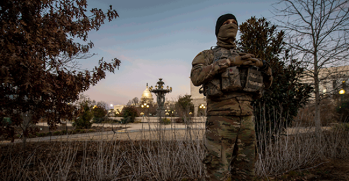 Member guarding grounds with the Capitol in the background.