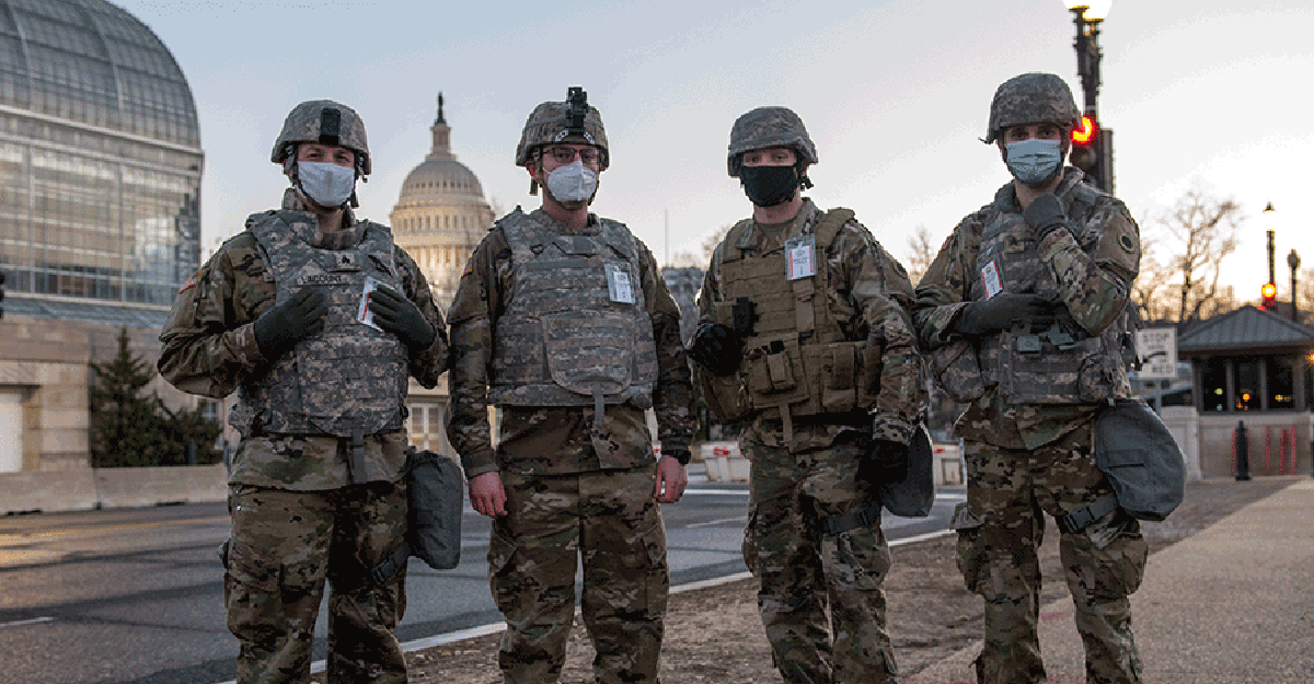 Four guard members guarding the Capitol area.