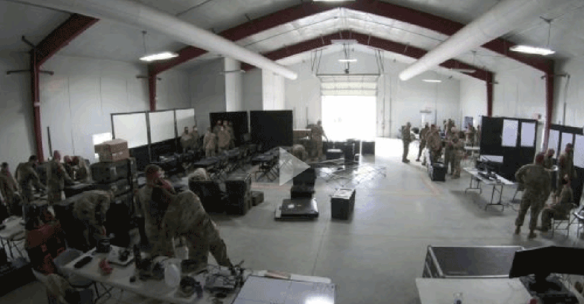 Still from video- Guard set up inside warehouse.