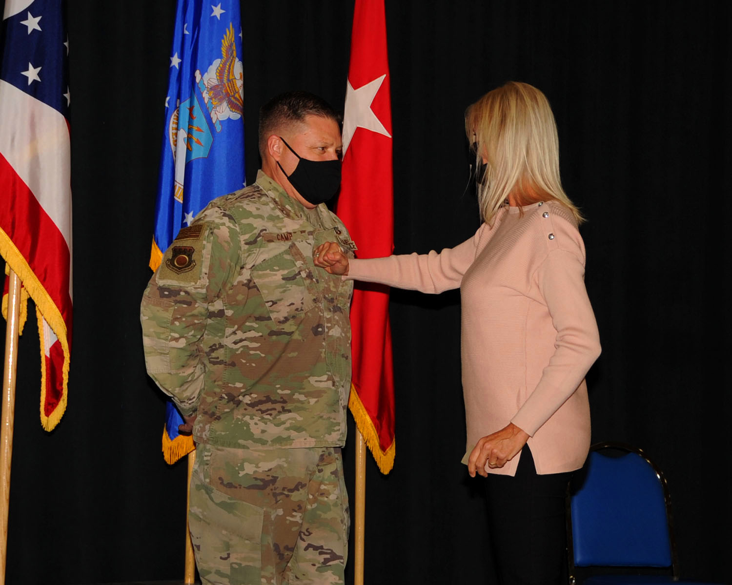 Maj. Gen. James R. Camp is “pinned”  by his wife.