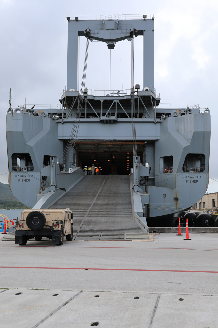 Soldiers load their vehicles onto the U.S. Naval Ship Fisher.
