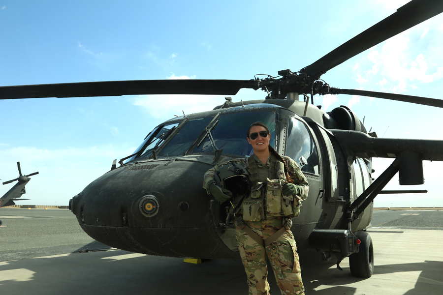 Chief Warrant Officer 2 Joanna Bradshaw stands in front of a Black Hawk.