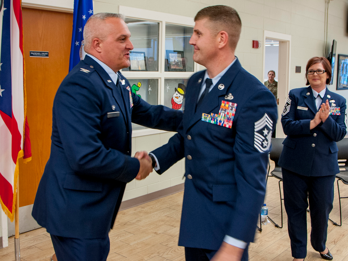 Chief Master Sgt. Troy Taylor shaking hands with Col. David Johnson