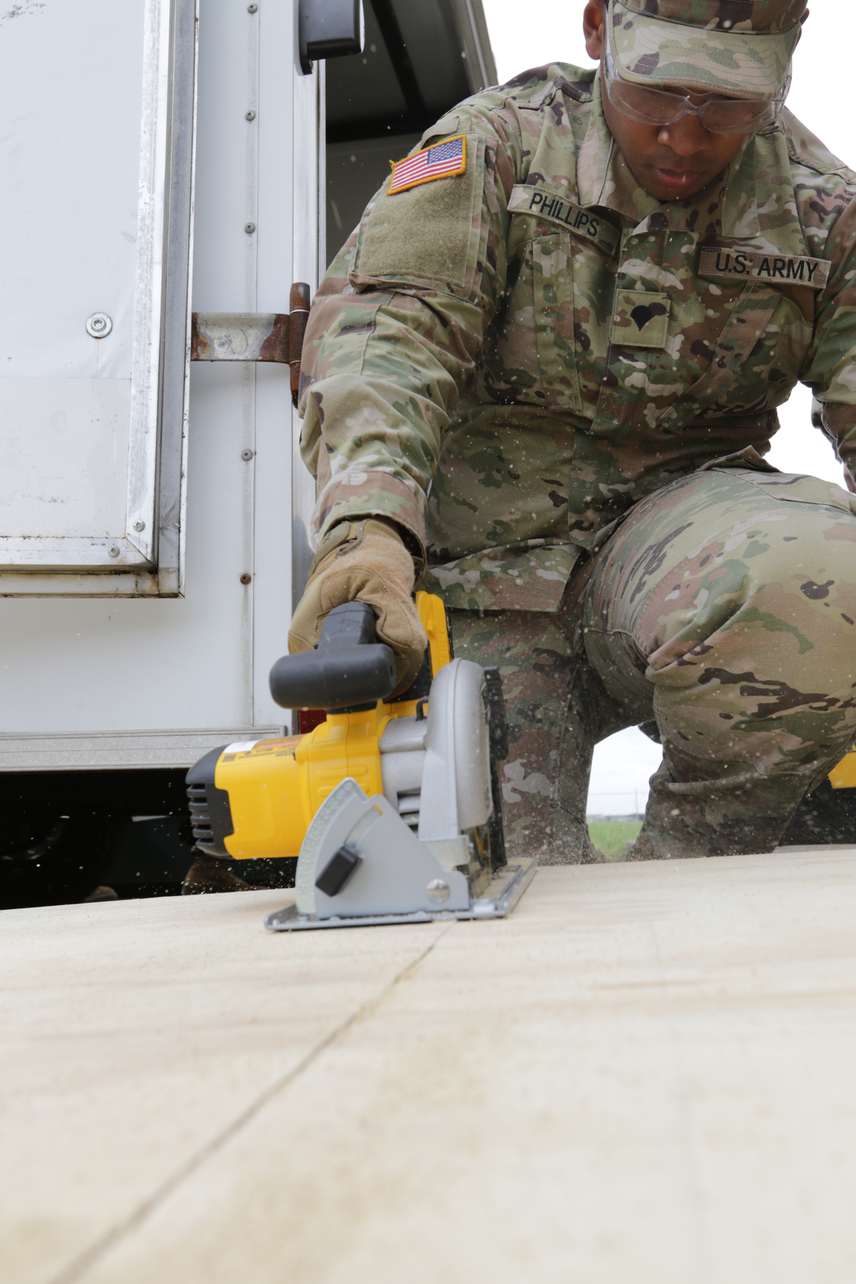 Soldier cutting plywood.