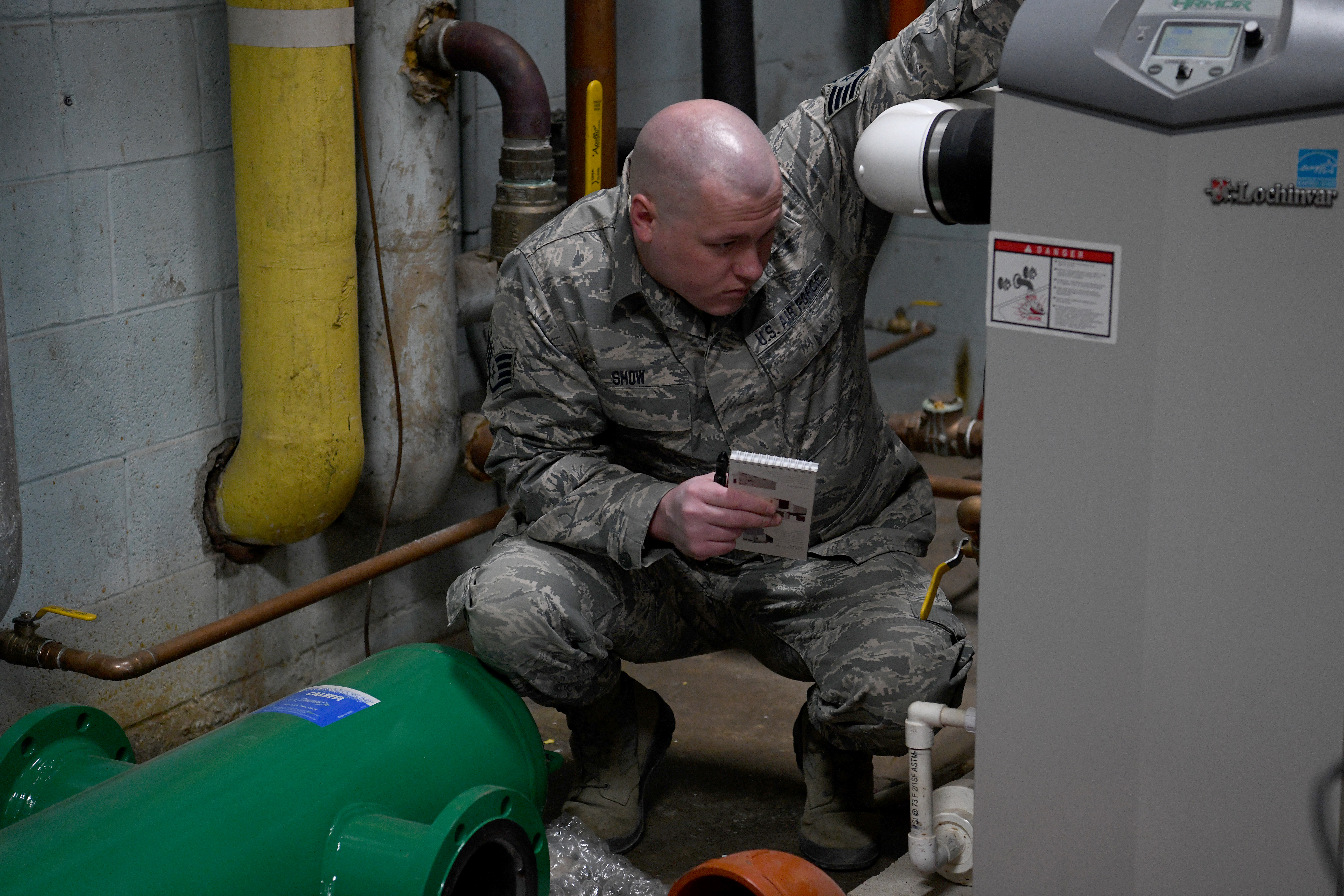 Airman inspects boiler.