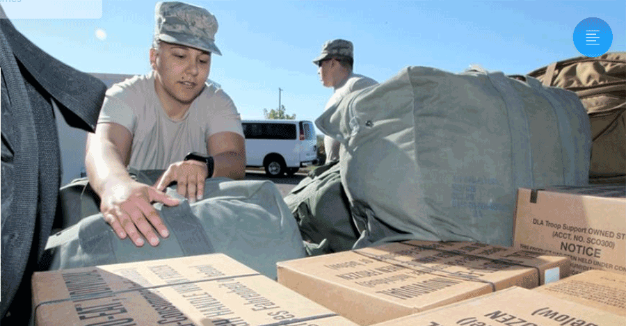 Soldiers unloading boxes off truck