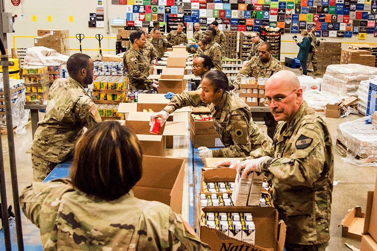 Soldiers pack boxes.