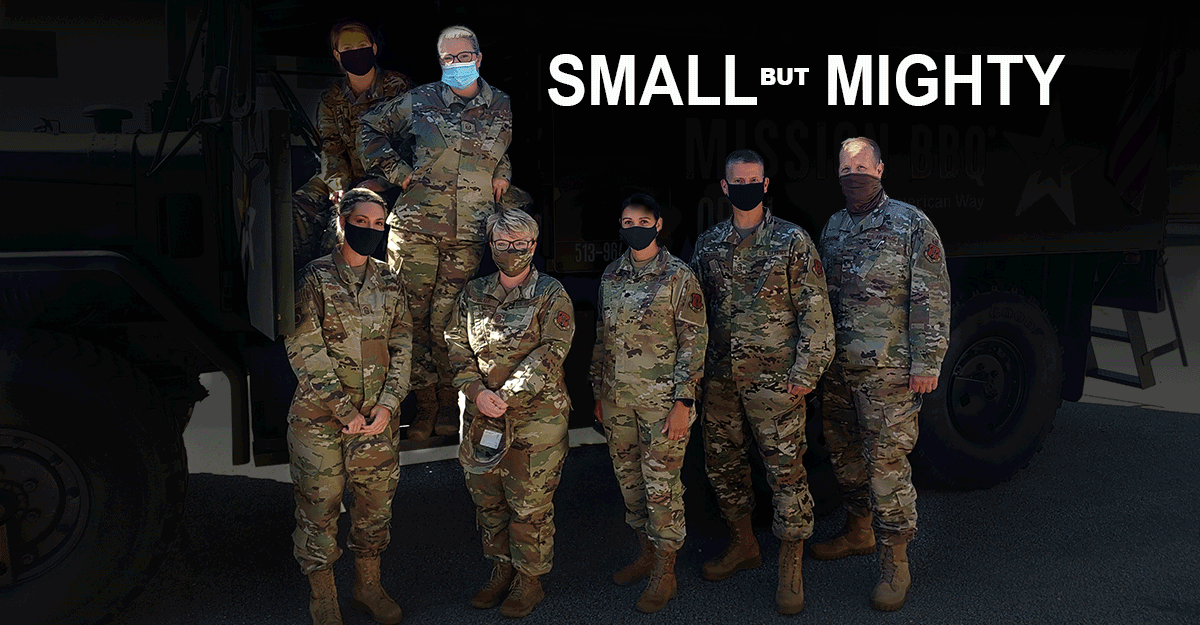 Airmen pose for photo doning masks. 
