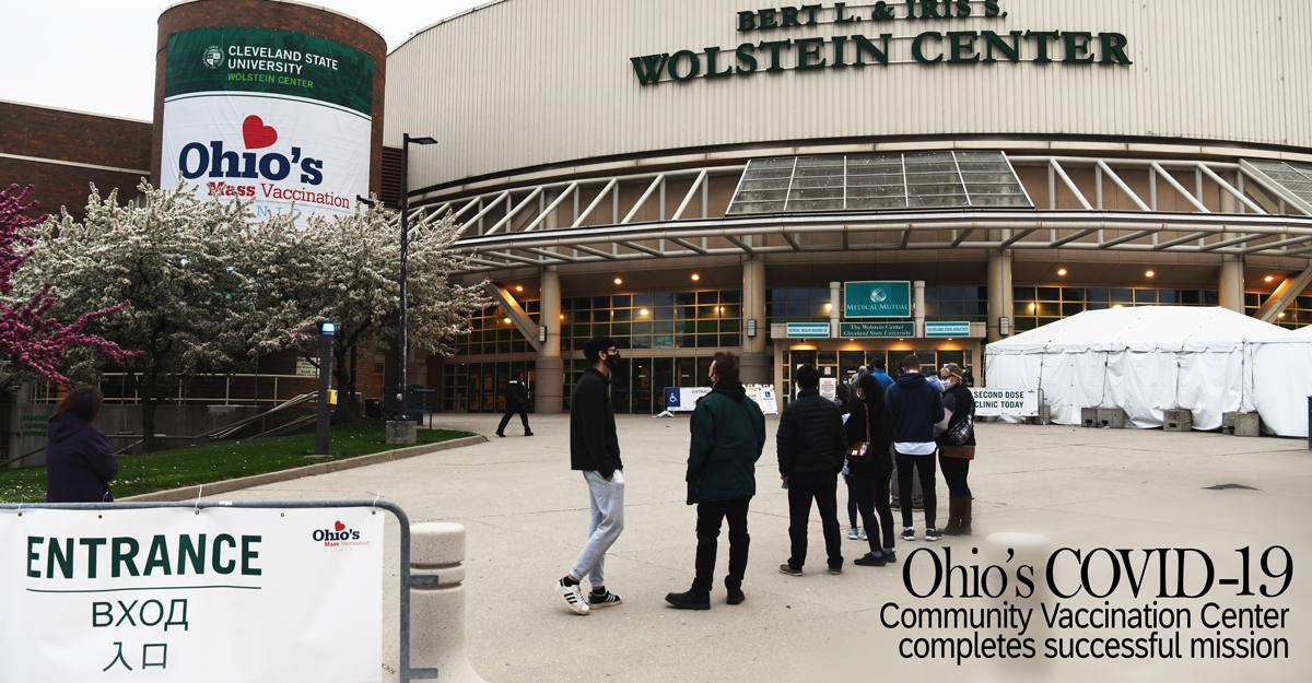 People wait in line outside Cleveland State University's Wolstein Center.