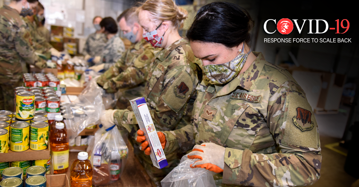 Guard members pack supplies in assembly line.

