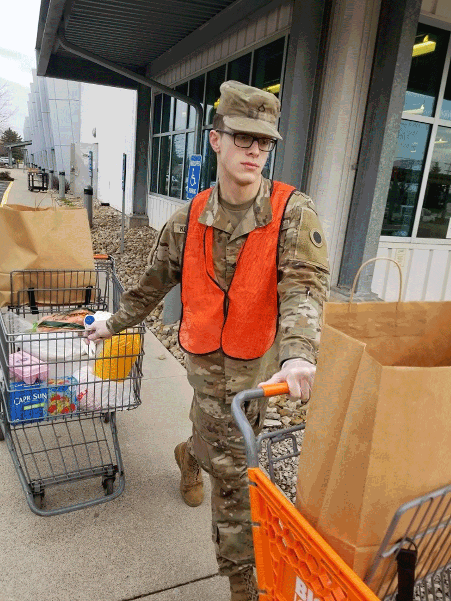 Soldier wheels out grocery carts of supplies.