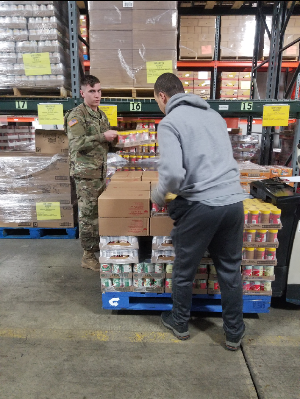 Soldier helps repack diapers for distribution .
