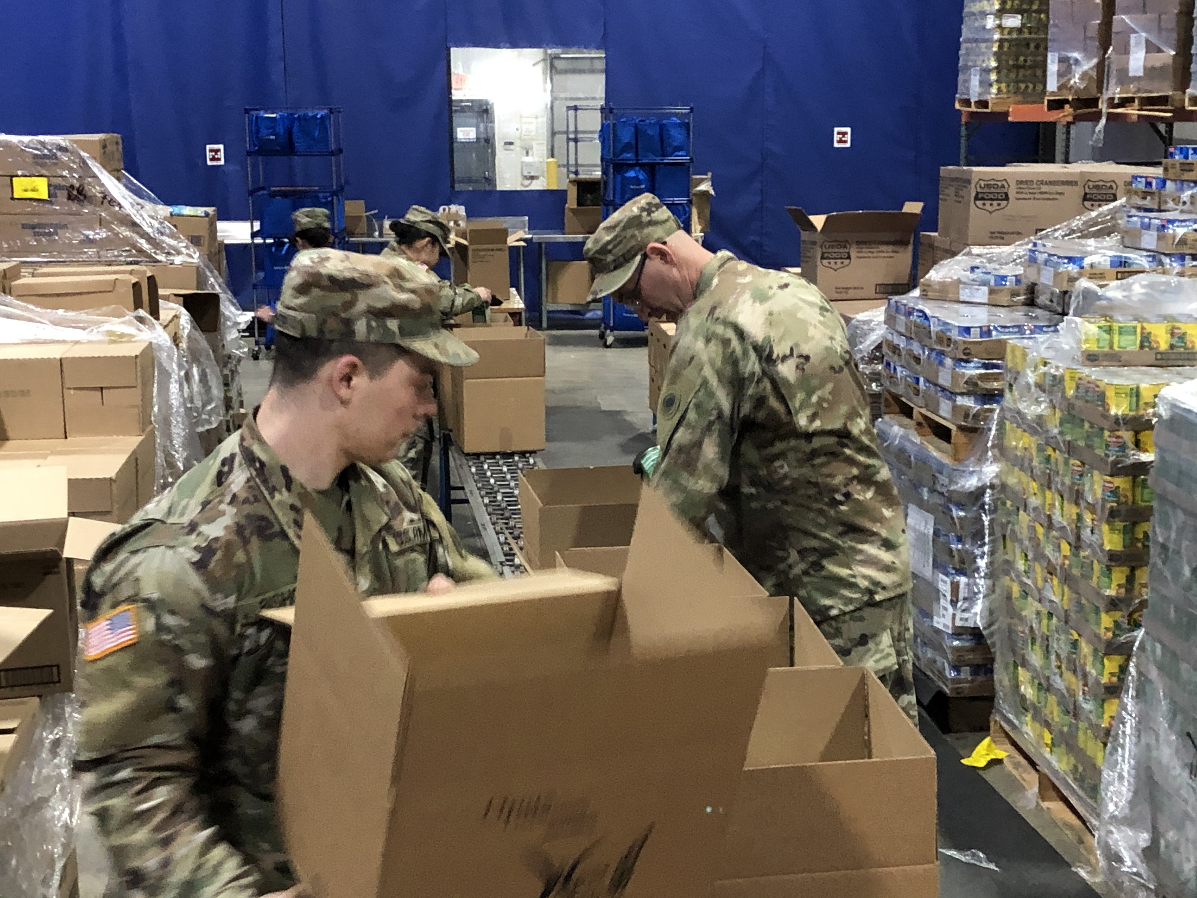 Soldiers load boxes.