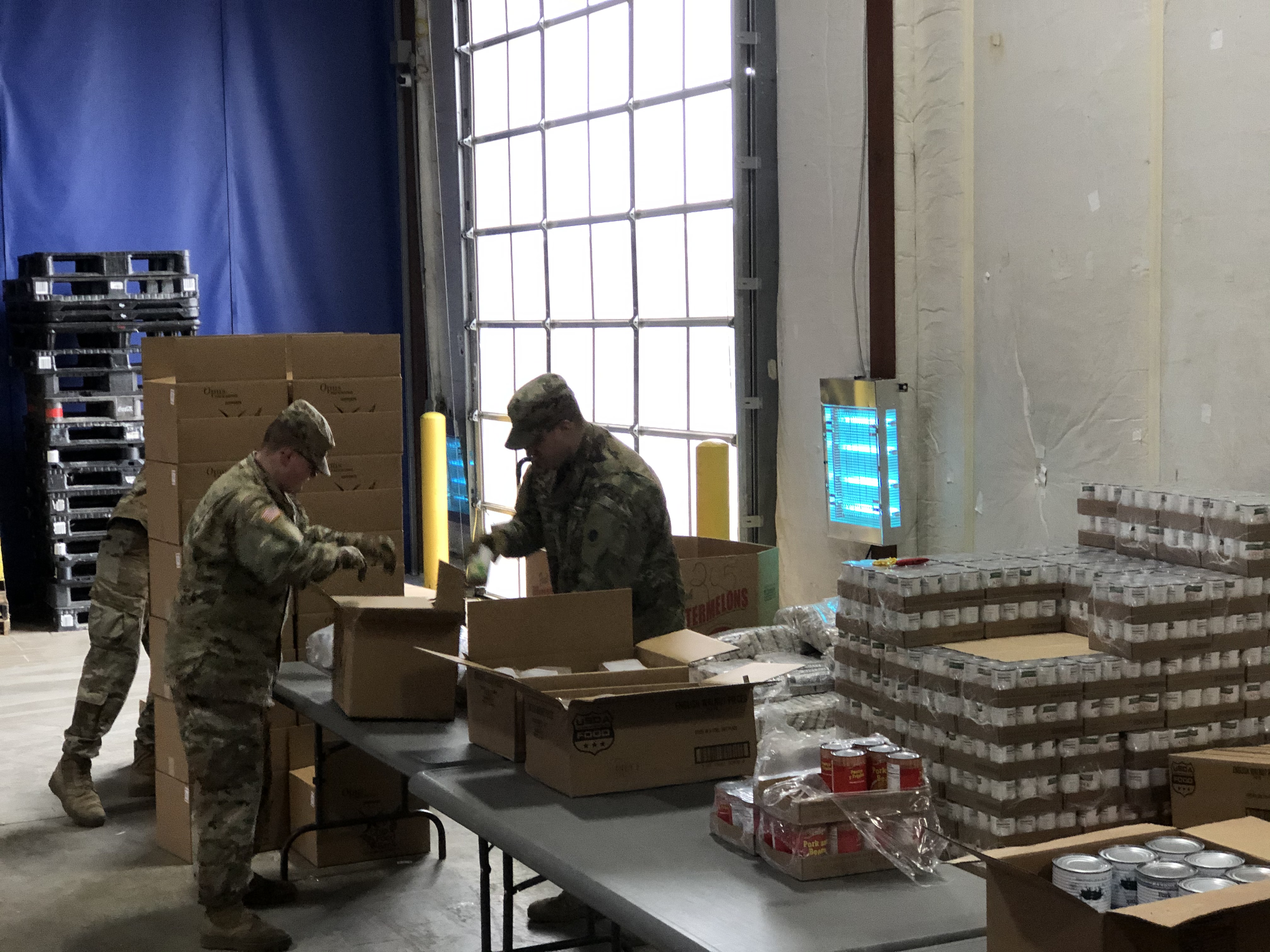 Soldiers load boxes.