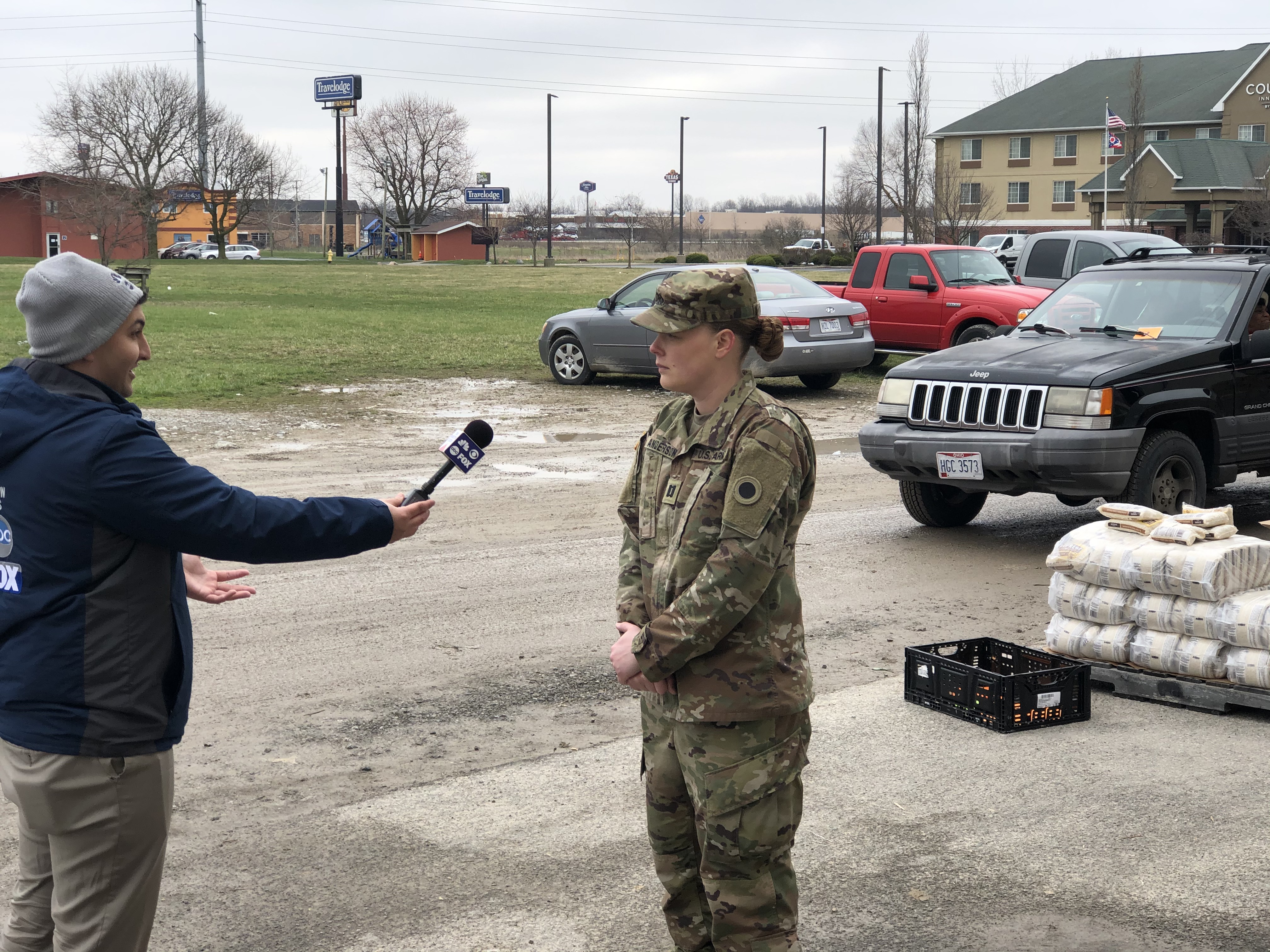 Soldier interviewed in parking lot.